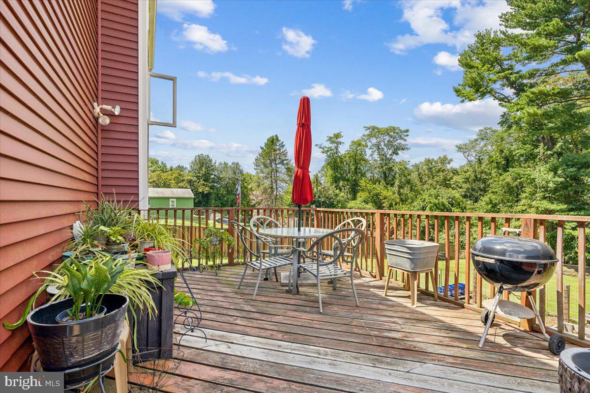 6936 Linganore Road Frederick, MD 21701 - Photo 28 of 33 a view of a balcony with chairs and wooden floor