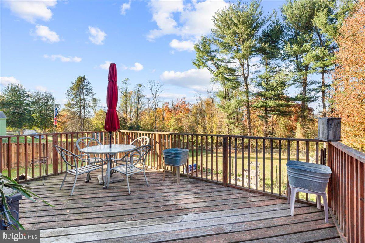 6936 Linganore Road Frederick, MD 21701 - Photo 29 of 33 a view of a balcony with wooden floor and outdoor seating