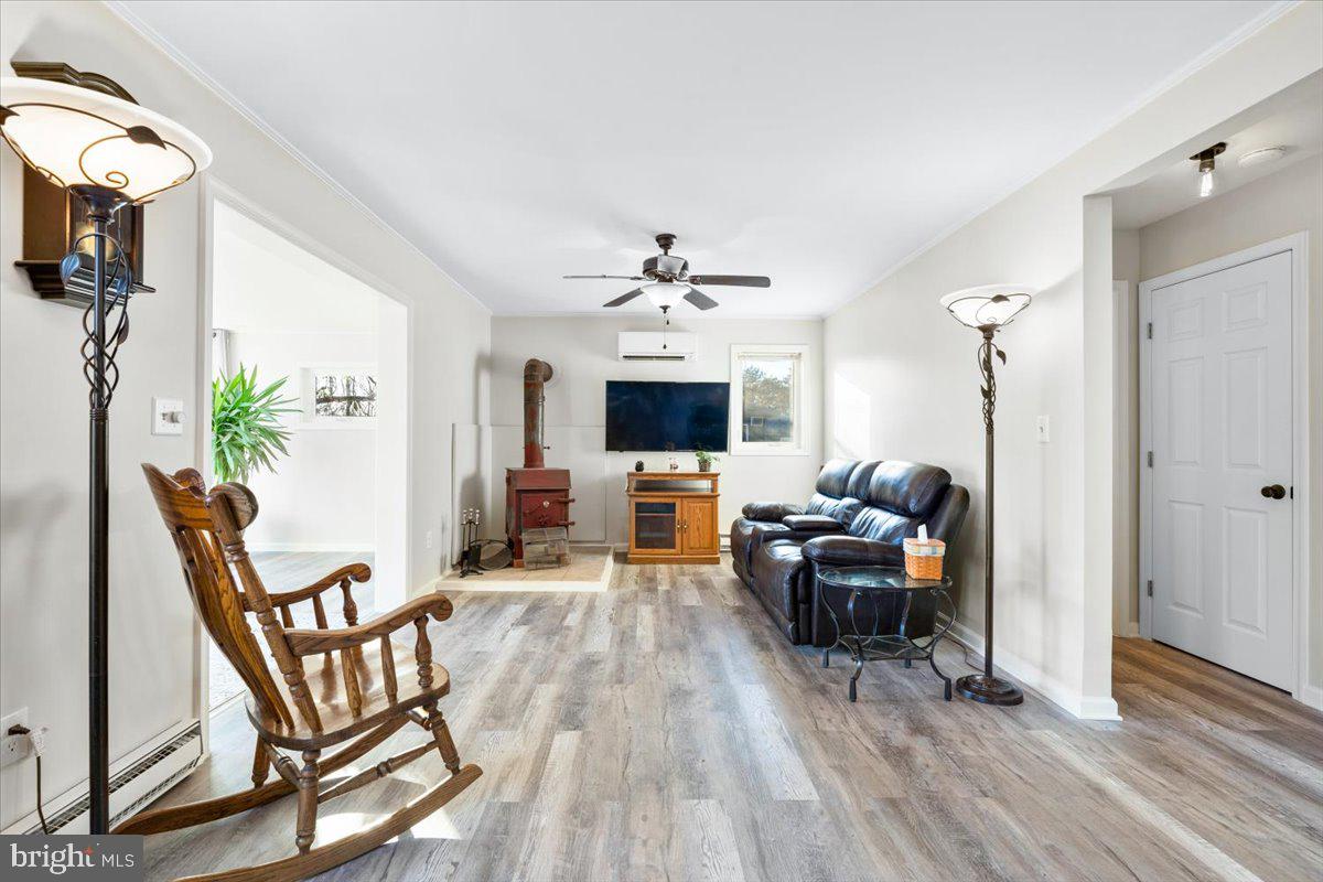 6936 Linganore Road Frederick, MD 21701 - Photo 5 of 33 a living room with furniture and a flat screen tv
