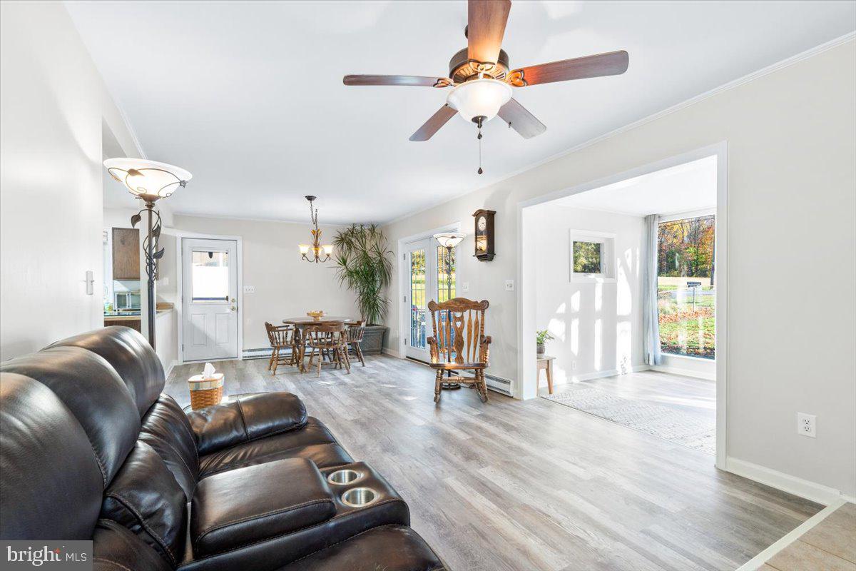 6936 Linganore Road Frederick, MD 21701 - Photo 7 of 33 a living room with furniture a ceiling fan and a rug