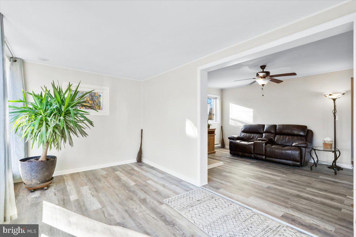 6936 Linganore Road Frederick, MD 21701 - Photo 9 of 33 a living room with furniture and a potted plant