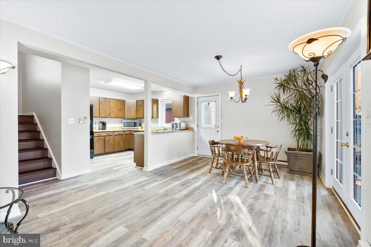 6936 Linganore Road Frederick, MD 21701 - Photo 10 of 33 a view of a dining room with furniture and wooden floor