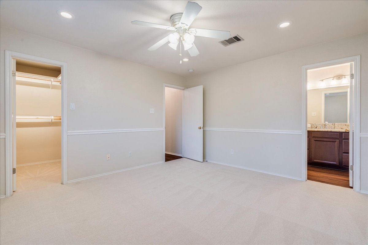 267 Carolyns Way Buda, TX 78610 - Photo 16 of 31 an empty room with closet and a chandelier fan