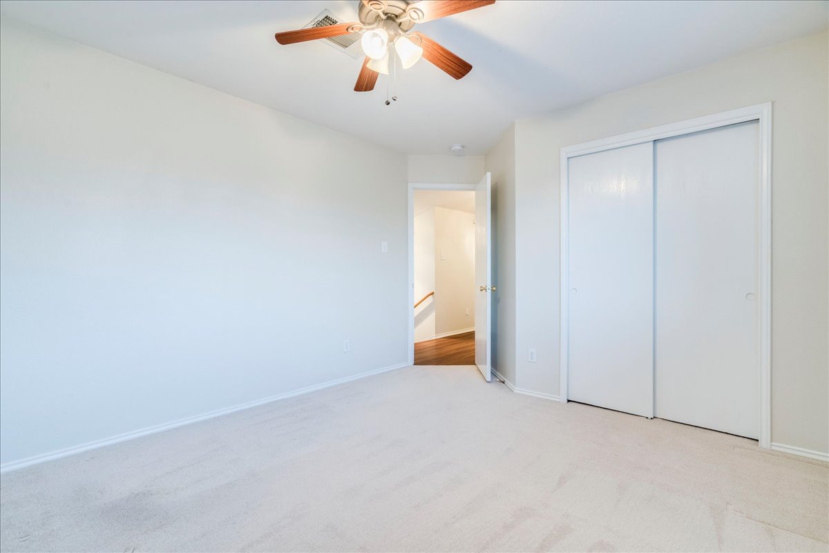 267 Carolyns Way Buda, TX 78610 - Photo 21 of 31 an empty room with a empty space and a ceiling fan