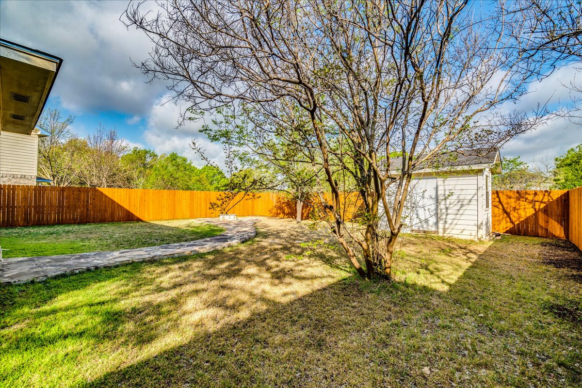 267 Carolyns Way Buda, TX 78610 - Photo 28 of 31 a view of yard with tree in the background