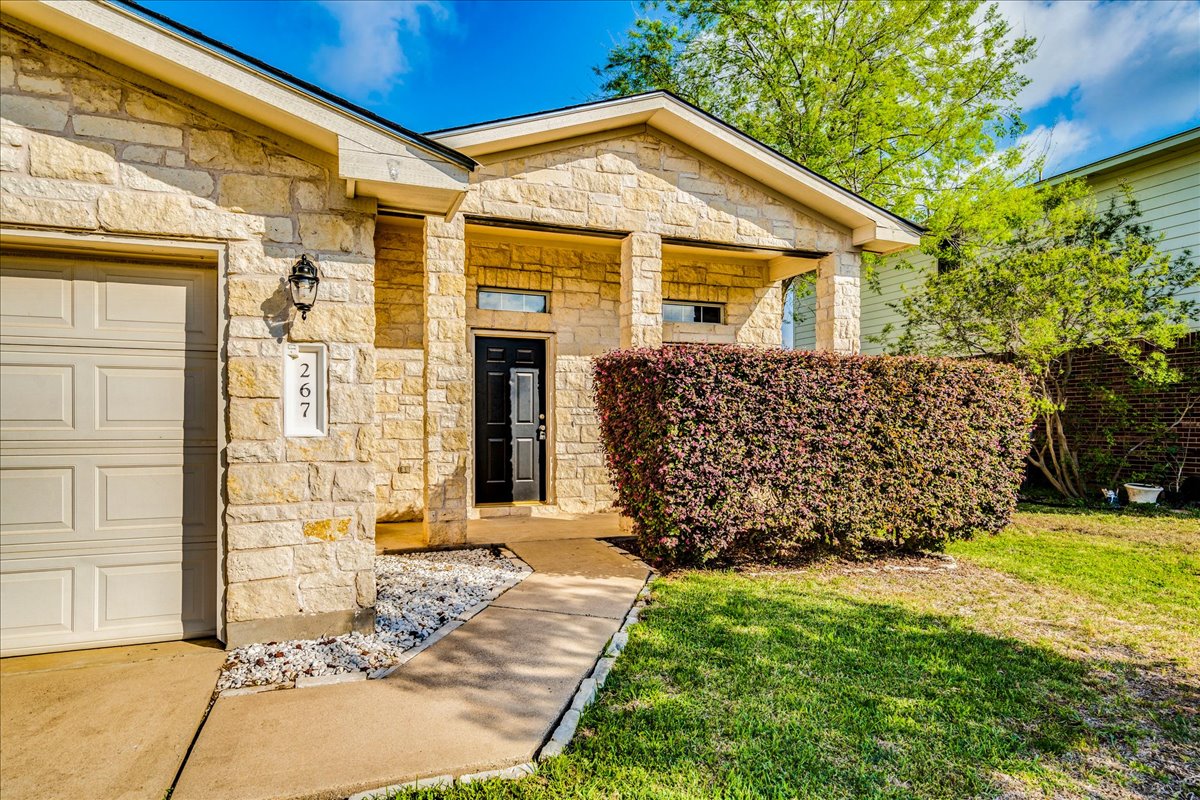 267 Carolyns Way Buda, TX 78610 - Photo 6 of 31 a front view of a house with a yard