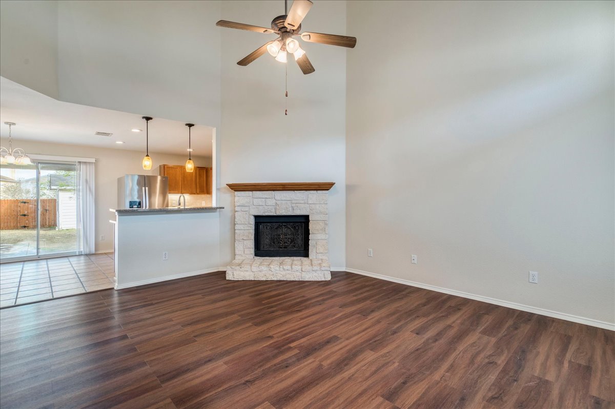 267 Carolyns Way Buda, TX 78610 - Photo 7 of 31 a view of a room wooden floor and a fireplace