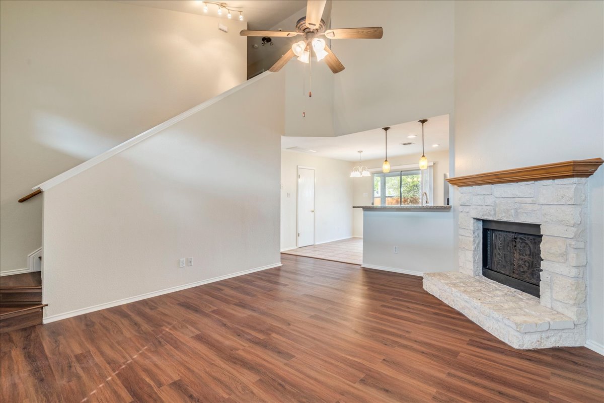 267 Carolyns Way Buda, TX 78610 - Photo 8 of 31 a view of empty room with wooden floor and fireplace