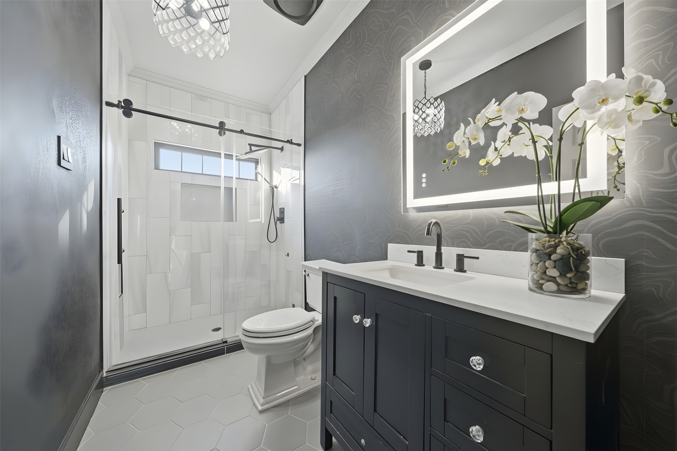 1918 Todville Road Seabrook, TX 77586 - Photo 19 of 41 Sophisticated second-level full bath featuring a striking floating vanity with backlit mirror, designer lighting, and an oversized walk-in shower wrapped in sleek tile.