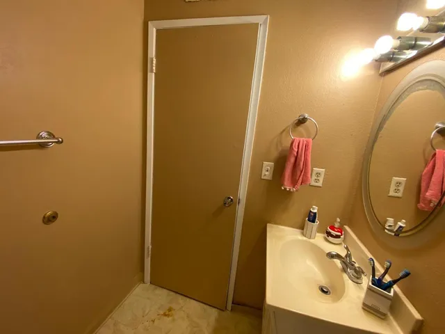 a bathroom with a sink a mirror and a toilet