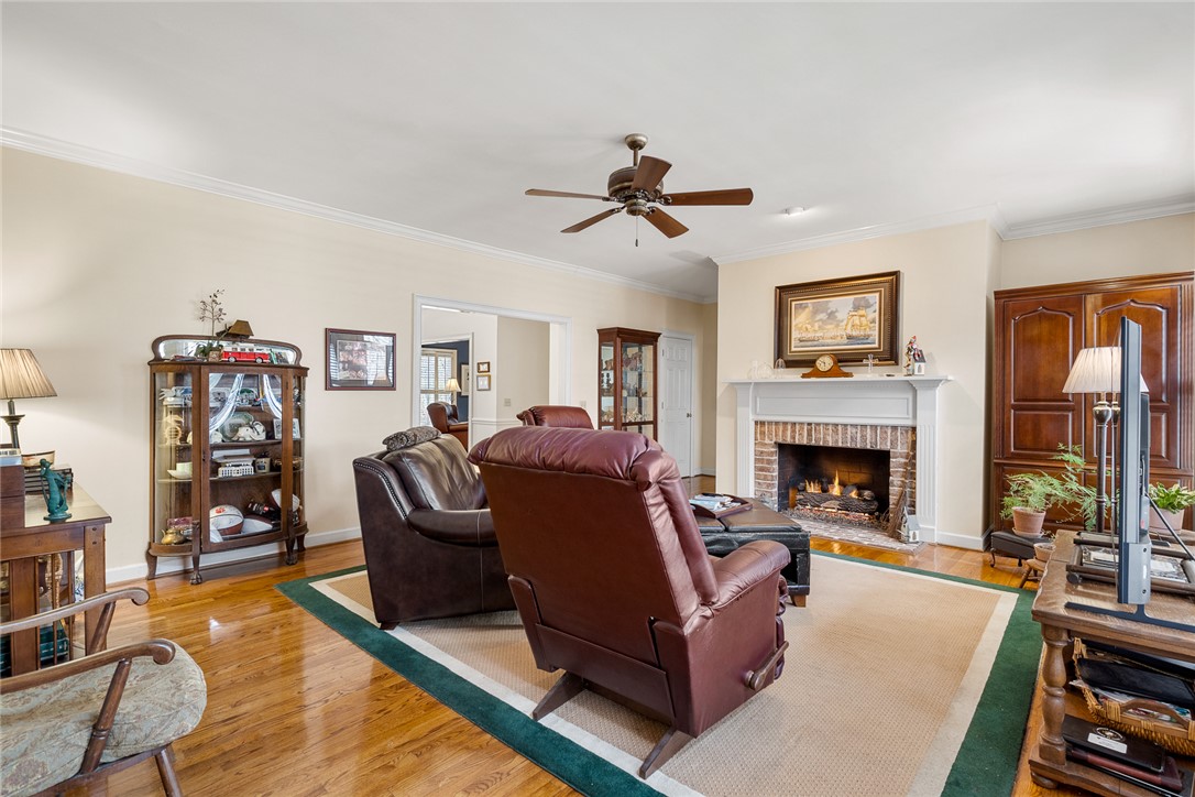 4011 Brackenberry Drive Anderson, SC 29621 - Photo 11 of 35 This inviting living area features warm wood flooring and a cozy fireplace, perfect for relaxation.