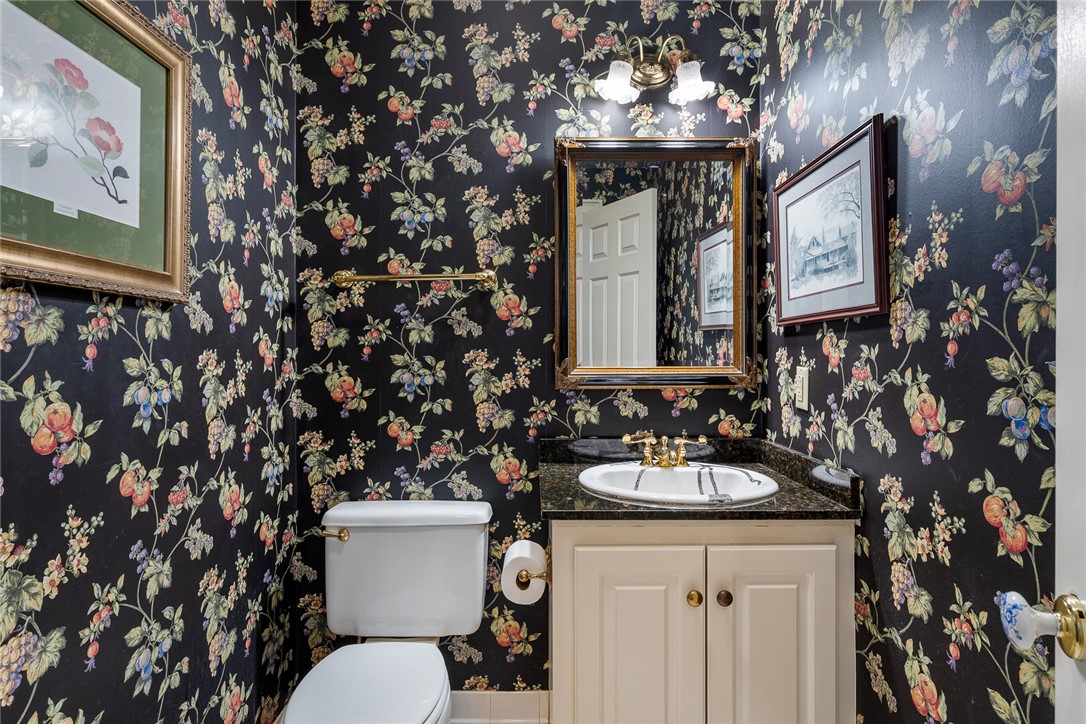 4011 Brackenberry Drive Anderson, SC 29621 - Photo 17 of 35 This bathroom showcases a vanity with a sleek countertop and a decorative mirror.