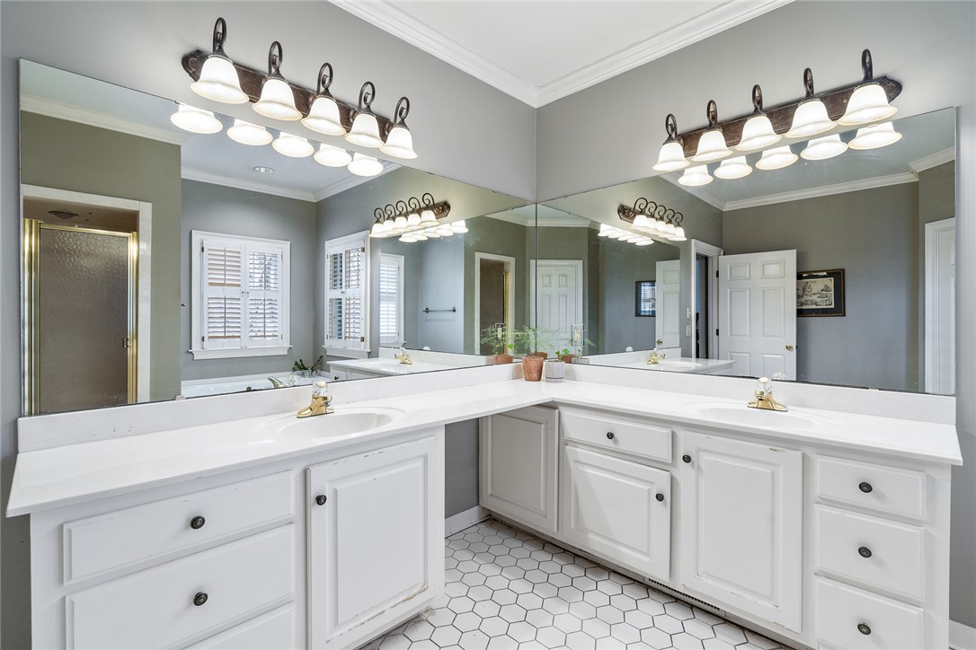 4011 Brackenberry Drive Anderson, SC 29621 - Photo 20 of 35 This bathroom features dual vanities, white cabinetry, and hexagon tile flooring, reflecting ample light.