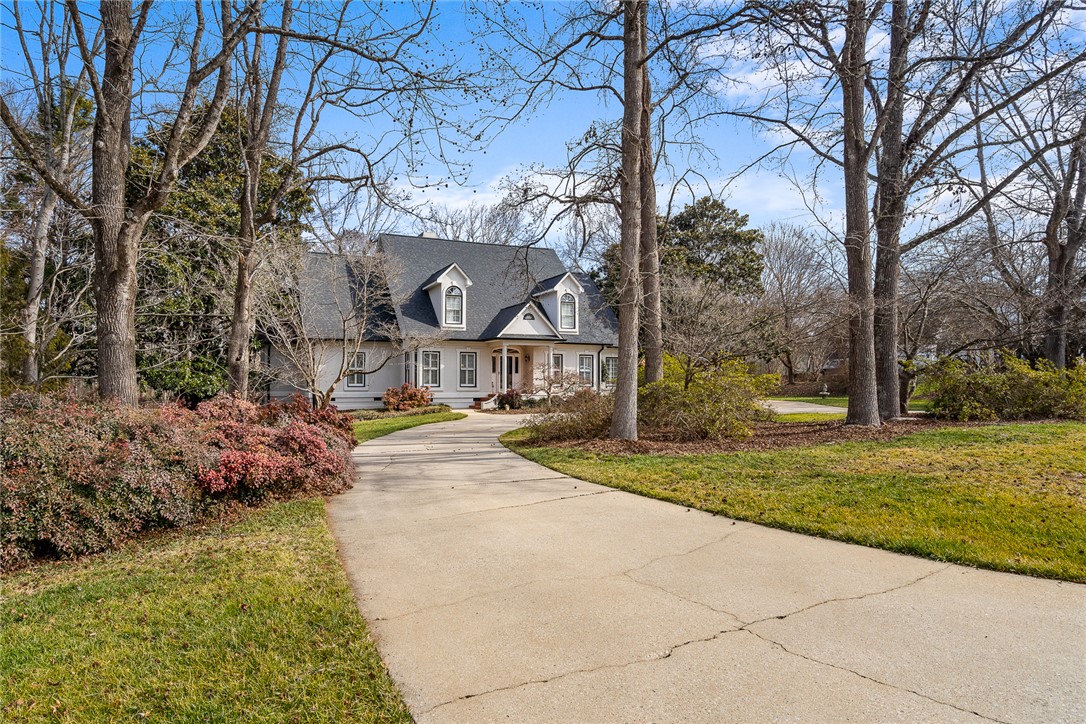 4011 Brackenberry Drive Anderson, SC 29621 - Photo 2 of 35 A charming residence awaits, featuring a graceful driveway and mature landscaping.