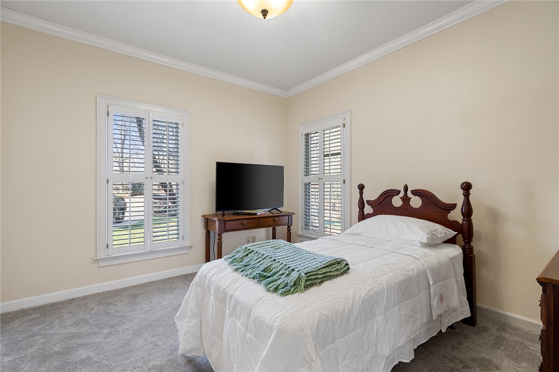 4011 Brackenberry Drive Anderson, SC 29621 - Photo 21 of 35 This cozy bedroom features plantation shutters, soft carpet, and classic crown molding.