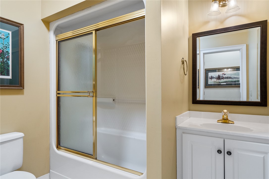 4011 Brackenberry Drive Anderson, SC 29621 - Photo 22 of 35 This bathroom features a sleek vanity and a shower-tub combination with elegant brass accents.