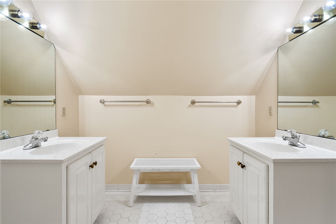 4011 Brackenberry Drive Anderson, SC 29621 - Photo 24 of 35 This bathroom features dual vanities and hexagonal floor tiling for a clean, symmetrical design.