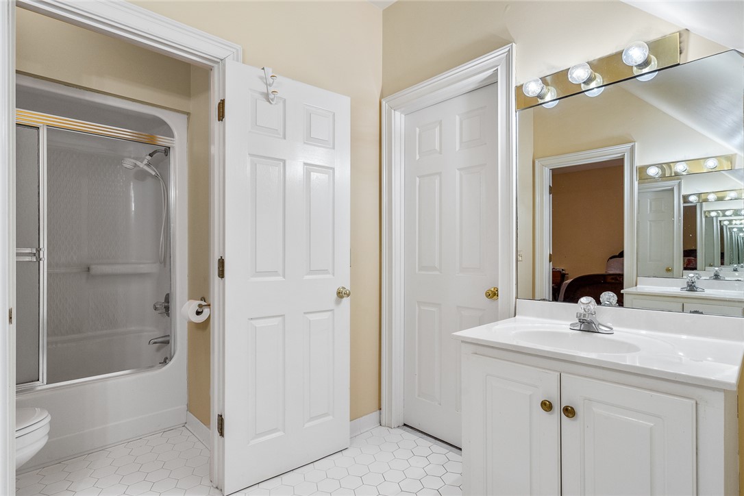 4011 Brackenberry Drive Anderson, SC 29621 - Photo 25 of 35 This bright bathroom features crisp white cabinetry and a classic tile floor.
