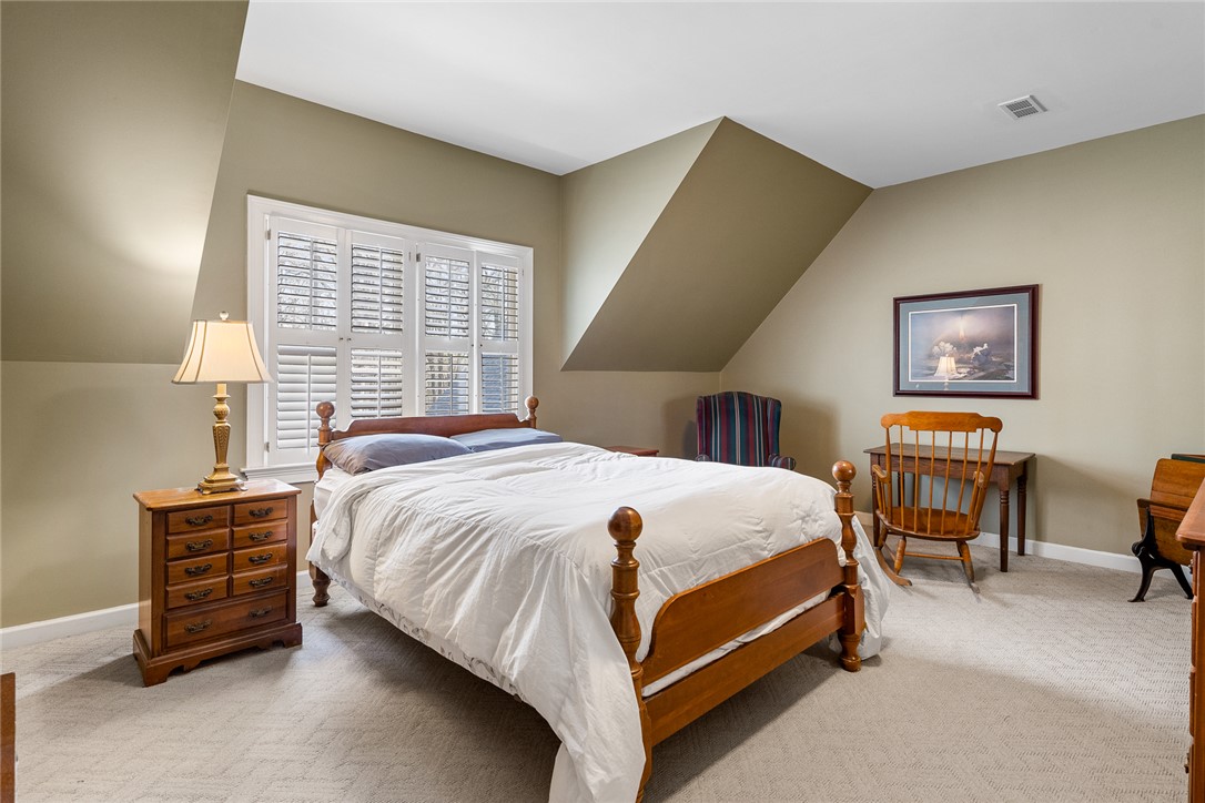 4011 Brackenberry Drive Anderson, SC 29621 - Photo 26 of 35 This cozy bedroom features sloped ceilings and ample natural light through window shutters.