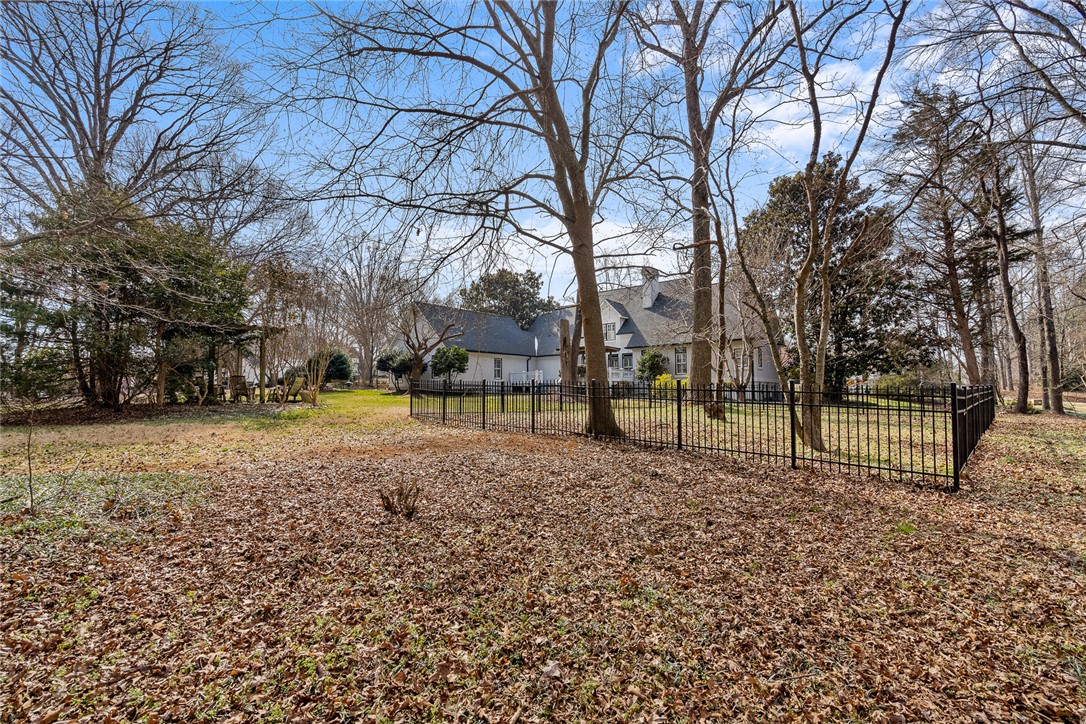 4011 Brackenberry Drive Anderson, SC 29621 - Photo 33 of 35 This spacious yard features mature trees and a sturdy fence, offering a private outdoor retreat.