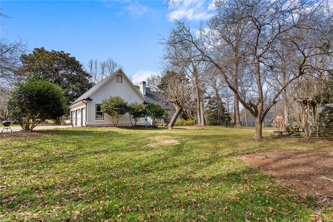 4011 Brackenberry Drive Anderson, SC 29621 - Photo 34 of 35 This spacious yard offers ample outdoor living space and features a charming home with an attached garage.