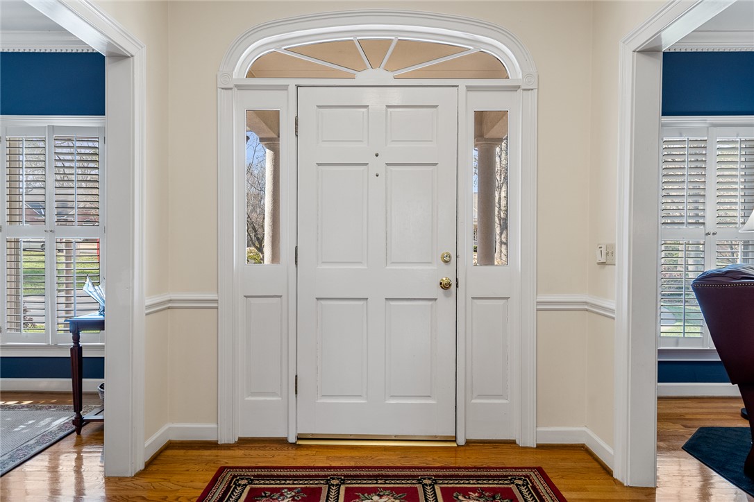 4011 Brackenberry Drive Anderson, SC 29621 - Photo 4 of 35 The bright entryway features a classic door with sidelights and an elegant transom, creating a welcoming ambiance.