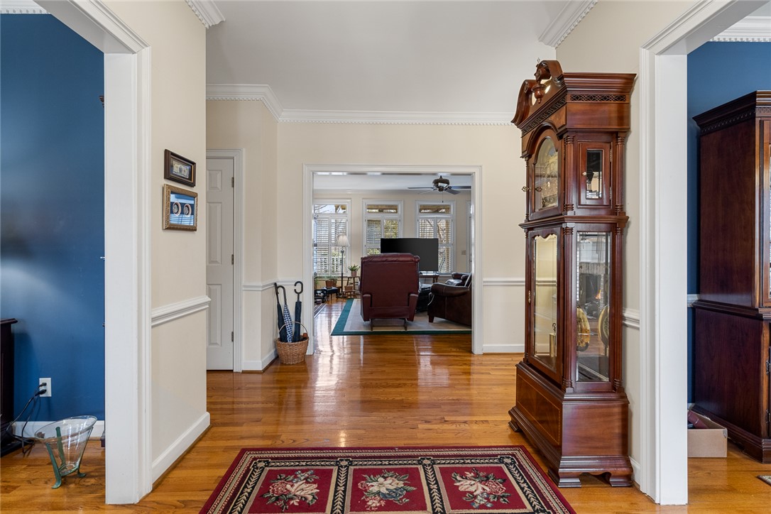 4011 Brackenberry Drive Anderson, SC 29621 - Photo 5 of 35 This inviting entrance foyer features polished wood floors and classic crown molding, leading to a spacious living area.