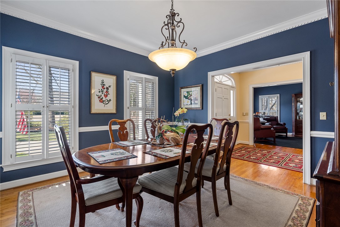 4011 Brackenberry Drive Anderson, SC 29621 - Photo 7 of 35 Elegant dining space, perfect for gatherings, features rich hardwood flooring and classic details.