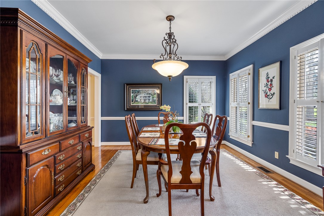 4011 Brackenberry Drive Anderson, SC 29621 - Photo 8 of 35 This formal dining space offers classic hardwood flooring, intricate crown molding, and abundant natural light.
