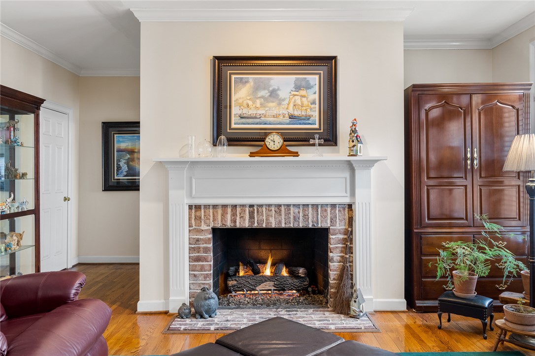 4011 Brackenberry Drive Anderson, SC 29621 - Photo 10 of 35 This living space features a cozy fireplace with a detailed mantel, perfect for gathering.