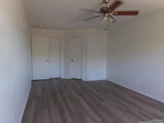 a view of a room with wooden floor