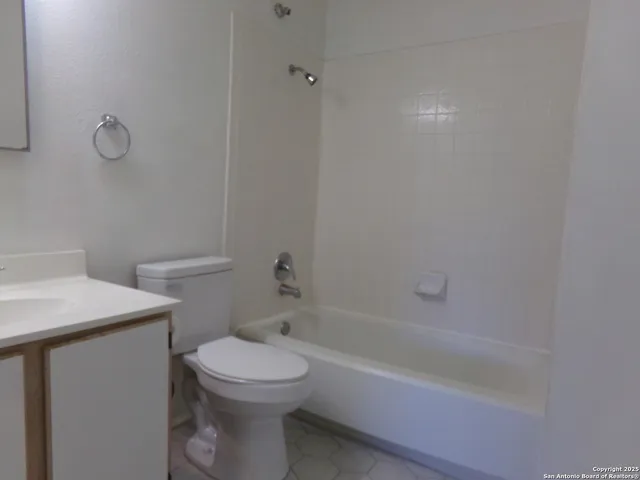 a bathroom with a sink a toilet and bathtub