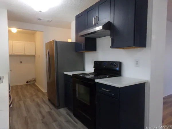 a kitchen with stainless steel appliances granite countertop a refrigerator stove and microwave