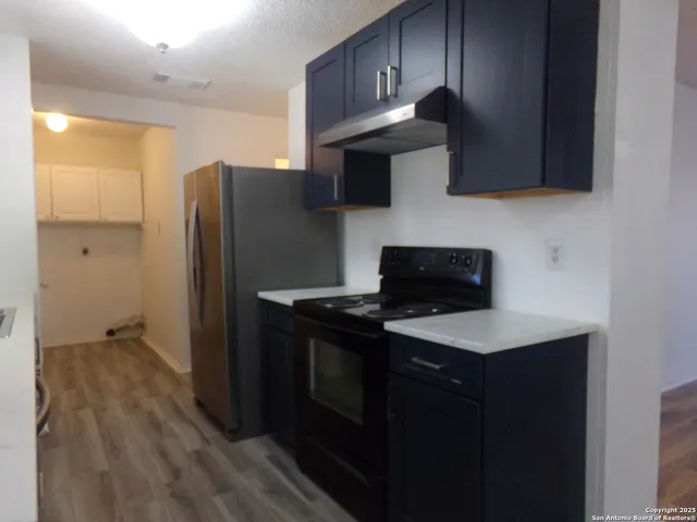 a kitchen with stainless steel appliances granite countertop a refrigerator stove and microwave