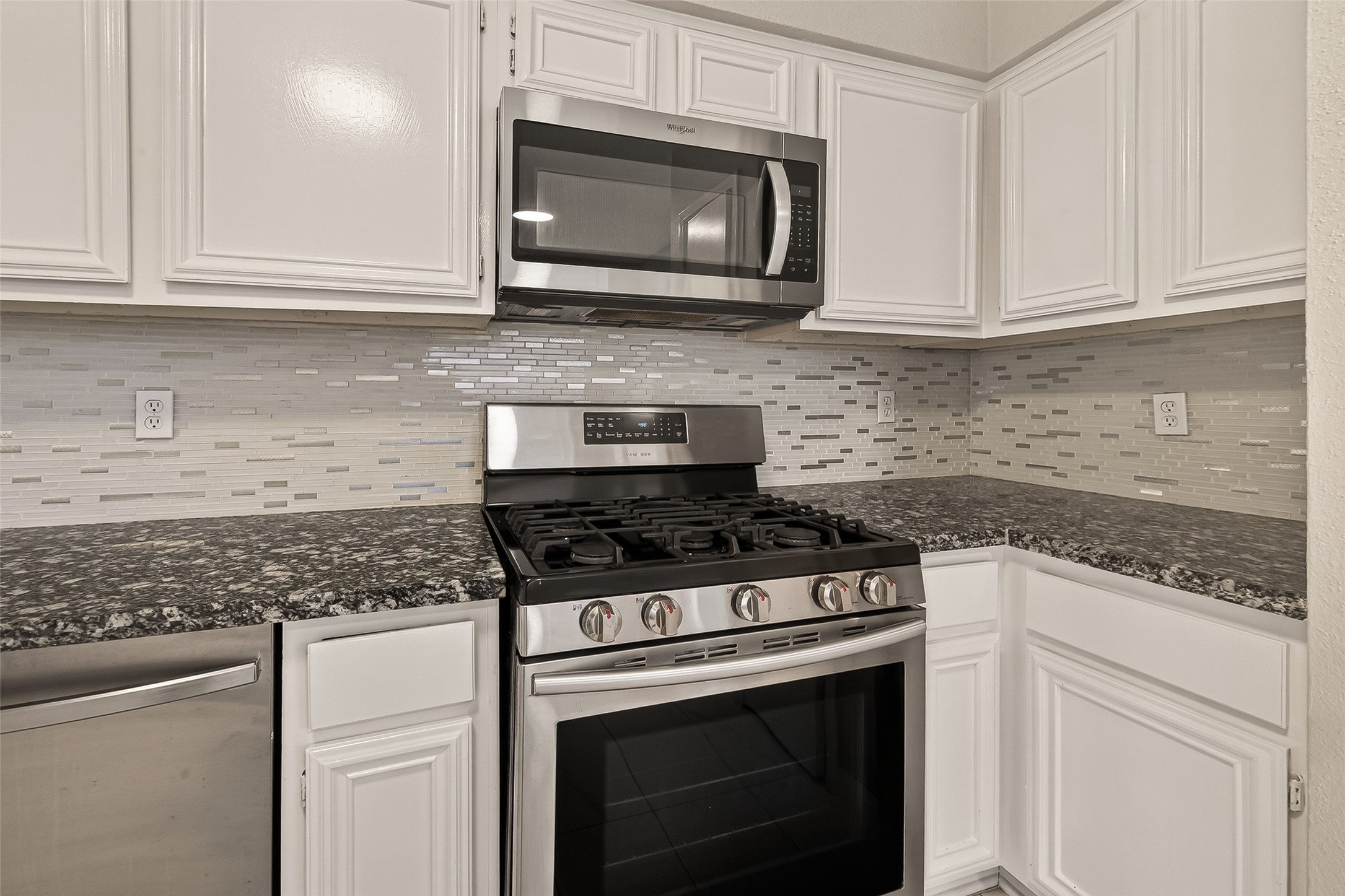 7622 Poitiers Drive Houston, TX 77071 - Photo 14 of 37 a kitchen with granite countertop white cabinets and stainless steel appliances