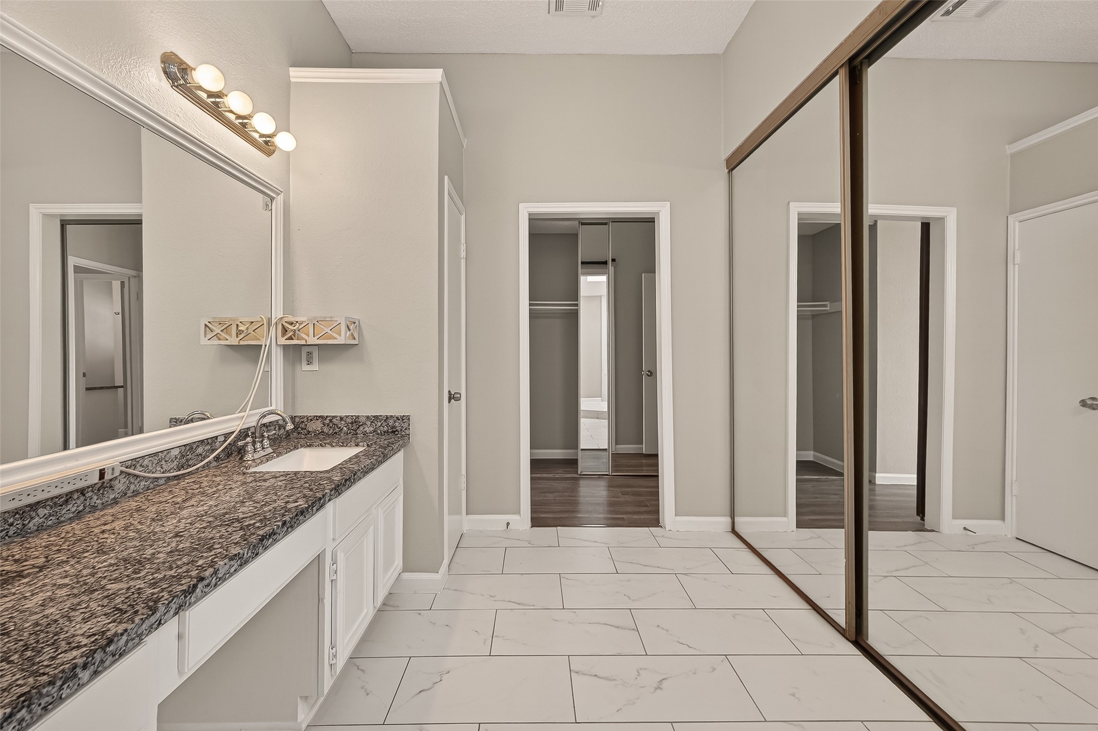 7622 Poitiers Drive Houston, TX 77071 - Photo 20 of 37 a bathroom with a granite countertop sink a mirror and a shower