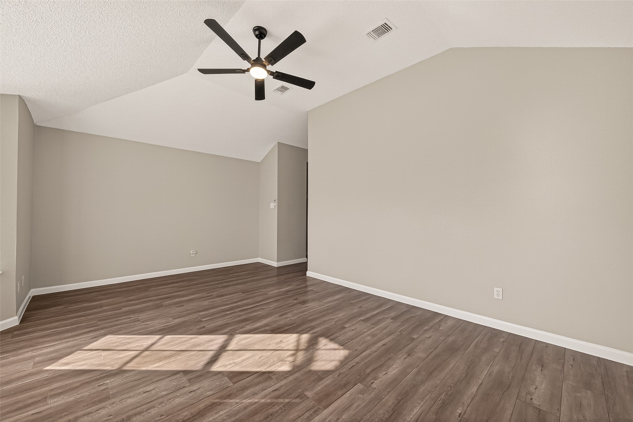 7622 Poitiers Drive Houston, TX 77071 - Photo 25 of 37 a view of a big room with wooden floor and a ceiling fan