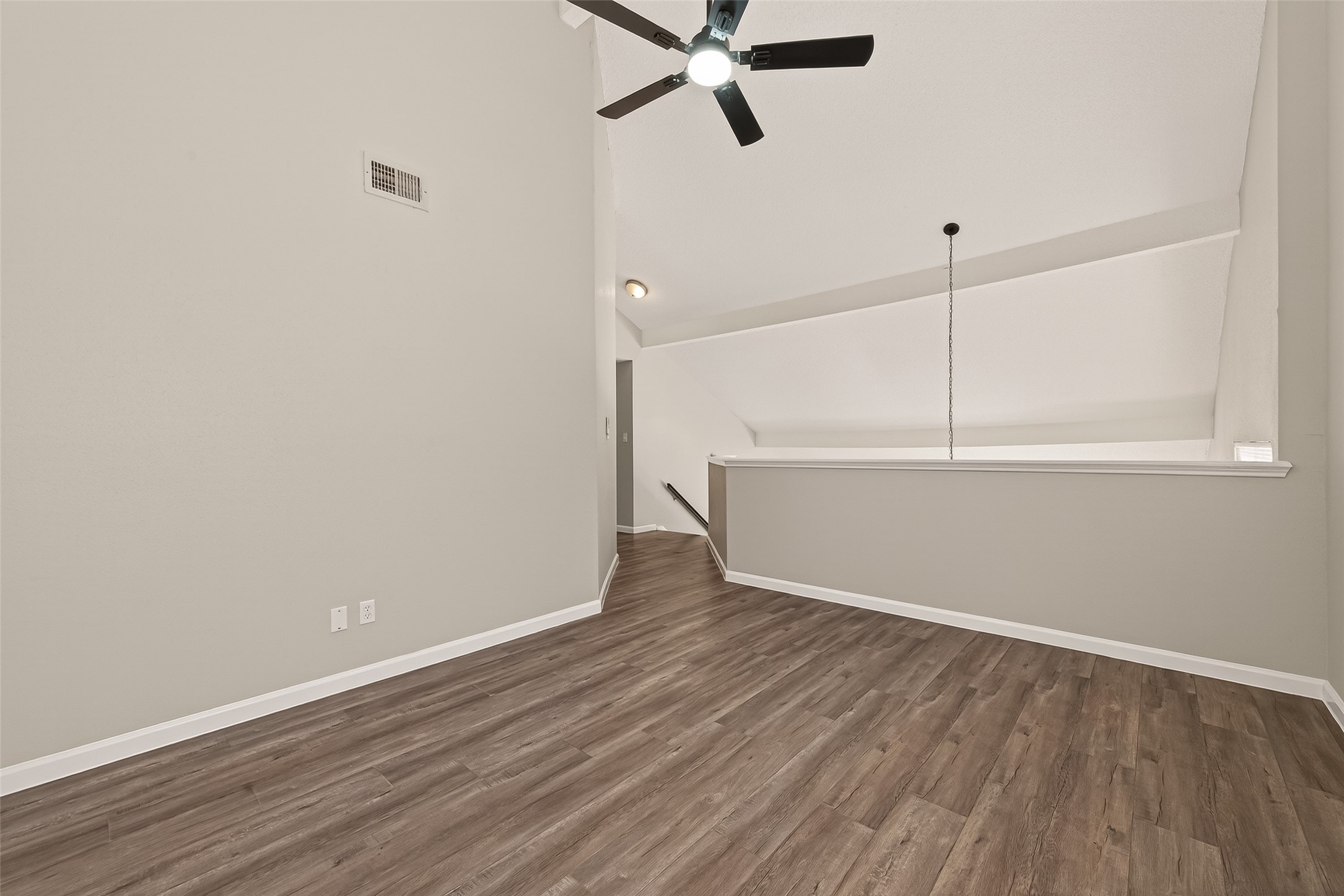 7622 Poitiers Drive Houston, TX 77071 - Photo 26 of 37 a view of an empty room with wooden floor and a ceiling fan