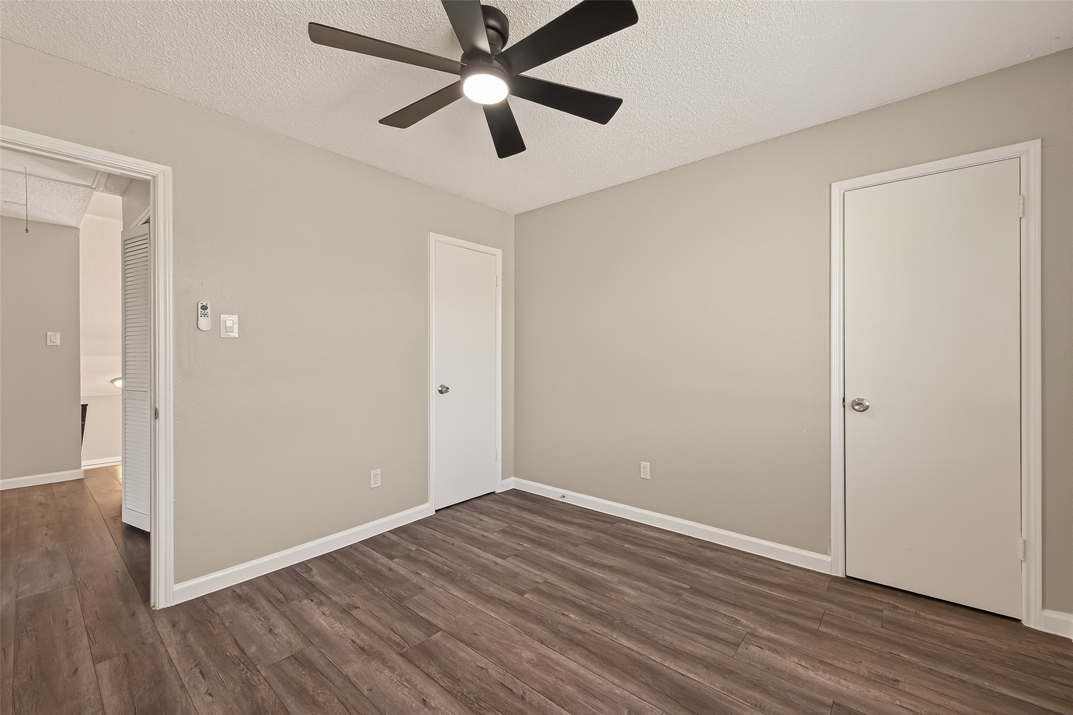 7622 Poitiers Drive Houston, TX 77071 - Photo 28 of 37 an empty room with wooden floor and a ceiling fan