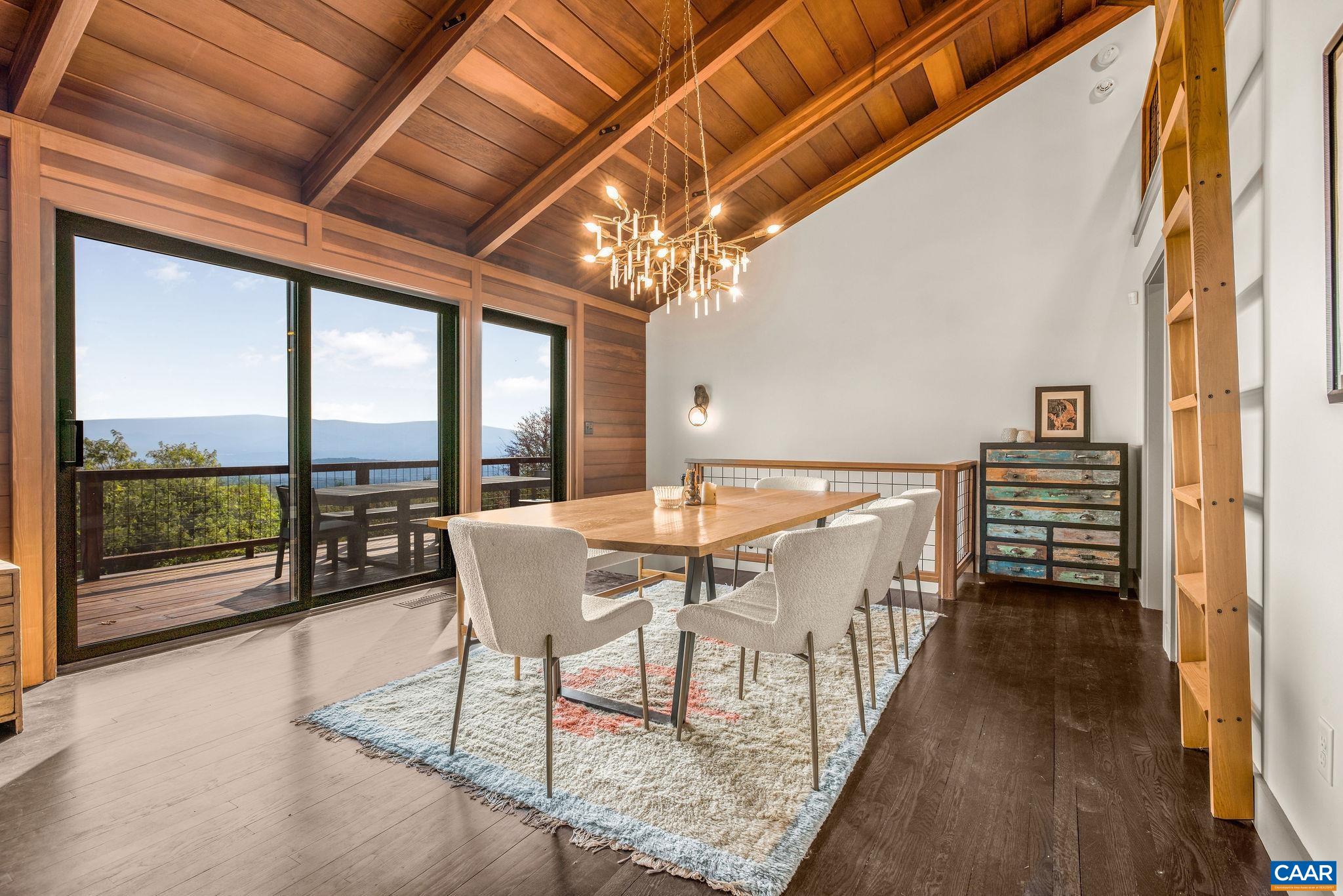 6288 Bryant Hollow Road Elkton, VA 22827 - Photo 25 of 54 a dining room with furniture and a floor to ceiling window