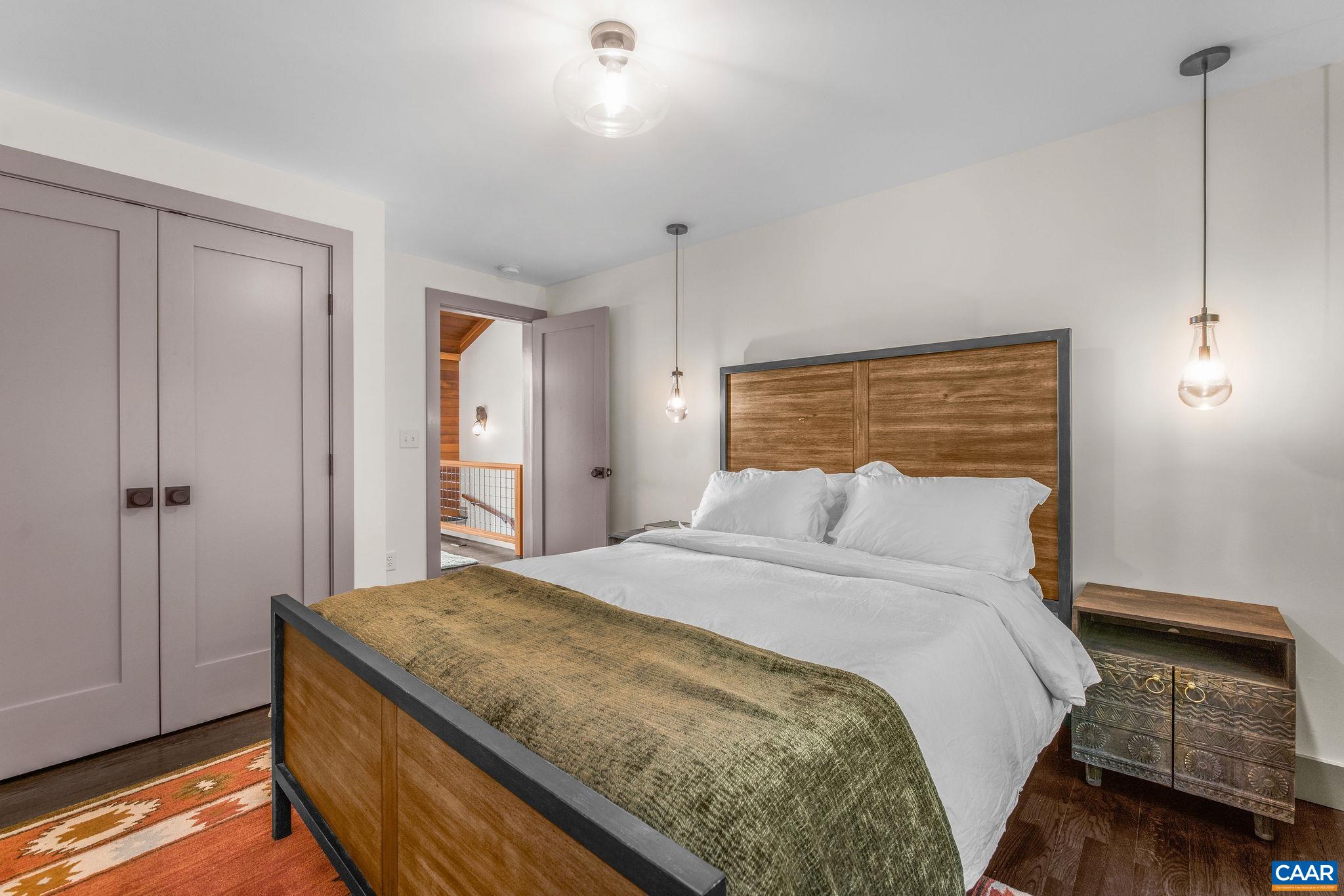 6288 Bryant Hollow Road Elkton, VA 22827 - Photo 33 of 54 a bedroom with a bed and wooden floor