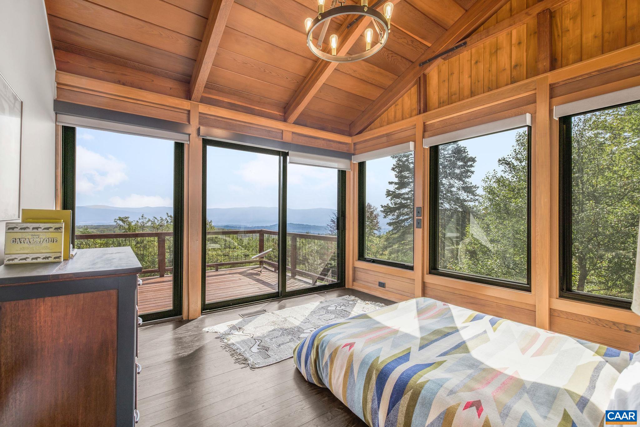 6288 Bryant Hollow Road Elkton, VA 22827 - Photo 35 of 54 a bedroom with furniture and large windows