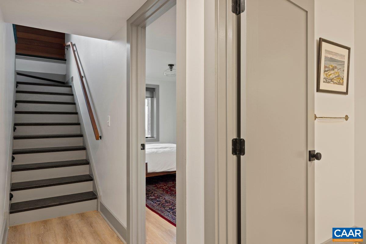 6288 Bryant Hollow Road Elkton, VA 22827 - Photo 38 of 54 a view of a hallway with wooden floor and staircase