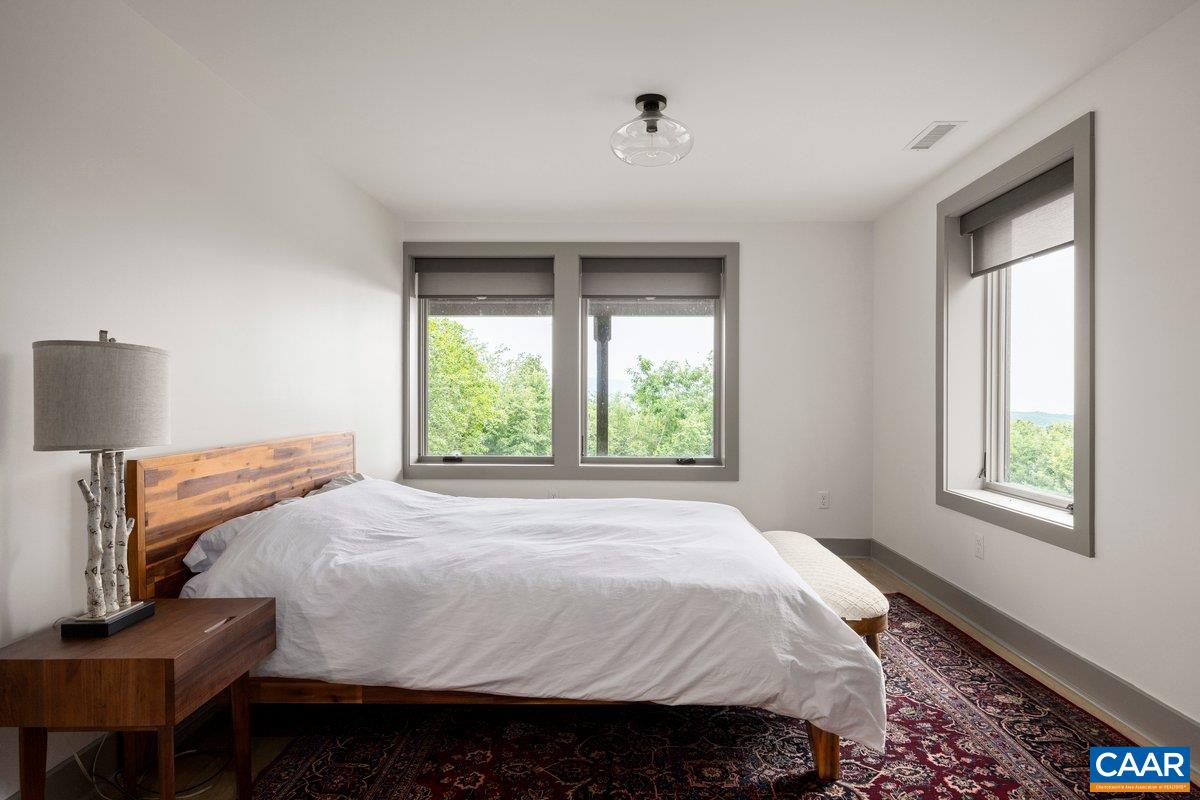 6288 Bryant Hollow Road Elkton, VA 22827 - Photo 41 of 54 a bed sitting in a bedroom next to a window