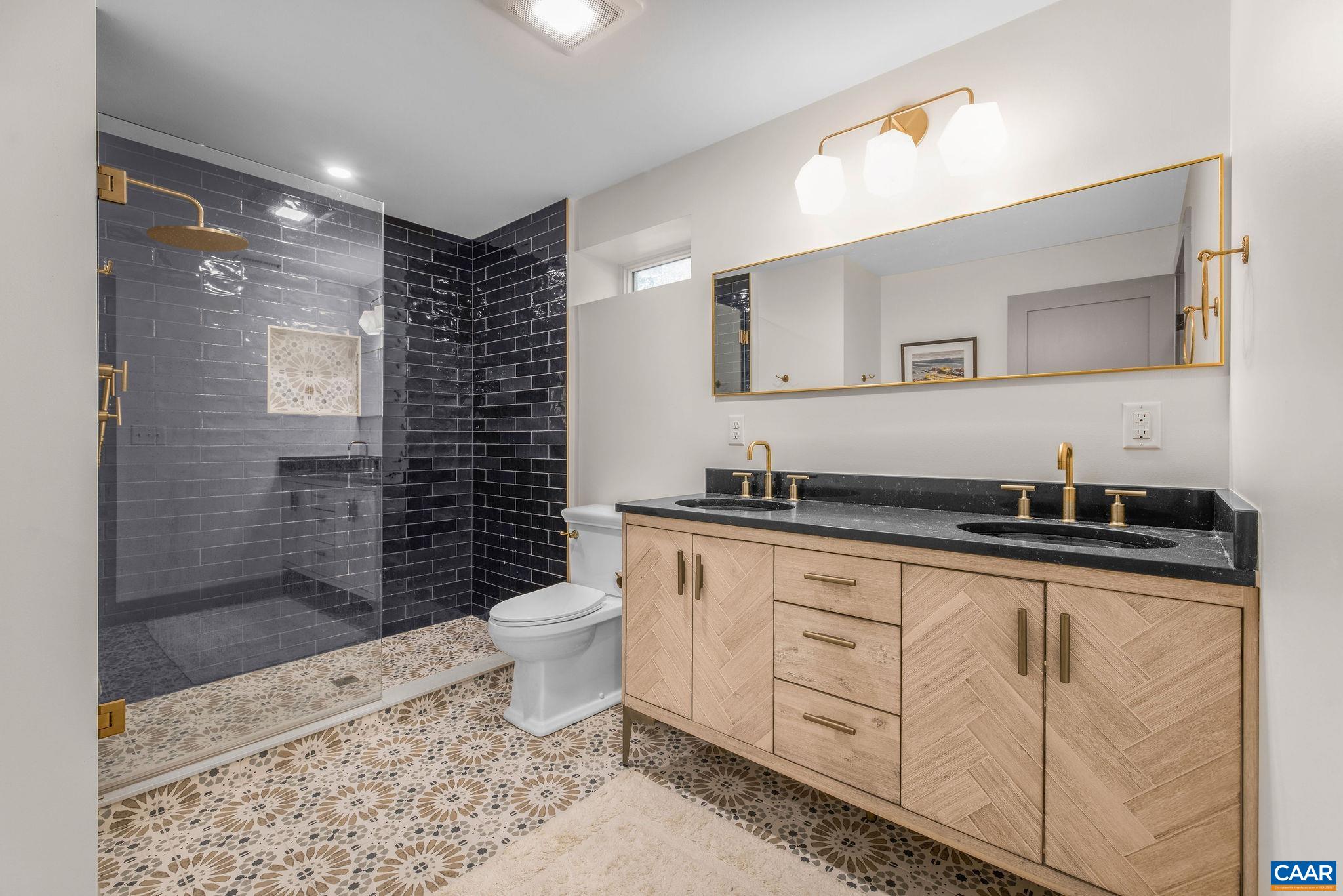 6288 Bryant Hollow Road Elkton, VA 22827 - Photo 42 of 54 a bathroom with a sink a toilet a mirror and shower