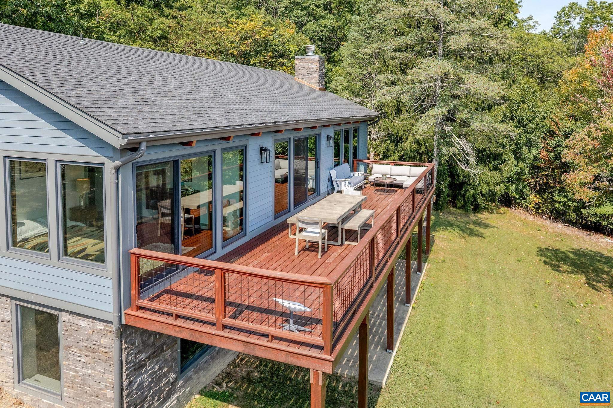 6288 Bryant Hollow Road Elkton, VA 22827 - Photo 8 of 54 a view of a balcony with two chairs and a table