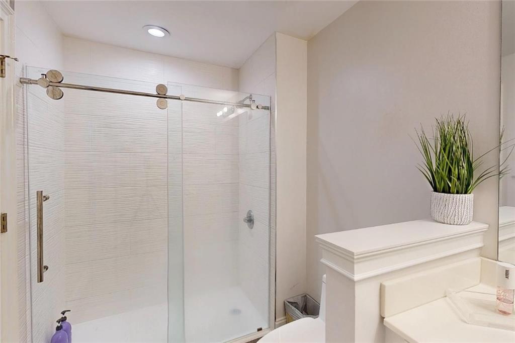 3275 Lenox Road Northeast, Unit 413 Atlanta, GA 30324 - Photo 35 of 52 a bathroom with a shower a sink and vanity