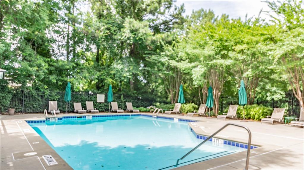 3275 Lenox Road Northeast, Unit 413 Atlanta, GA 30324 - Photo 48 of 52 a swimming pool with outdoor seating and yard