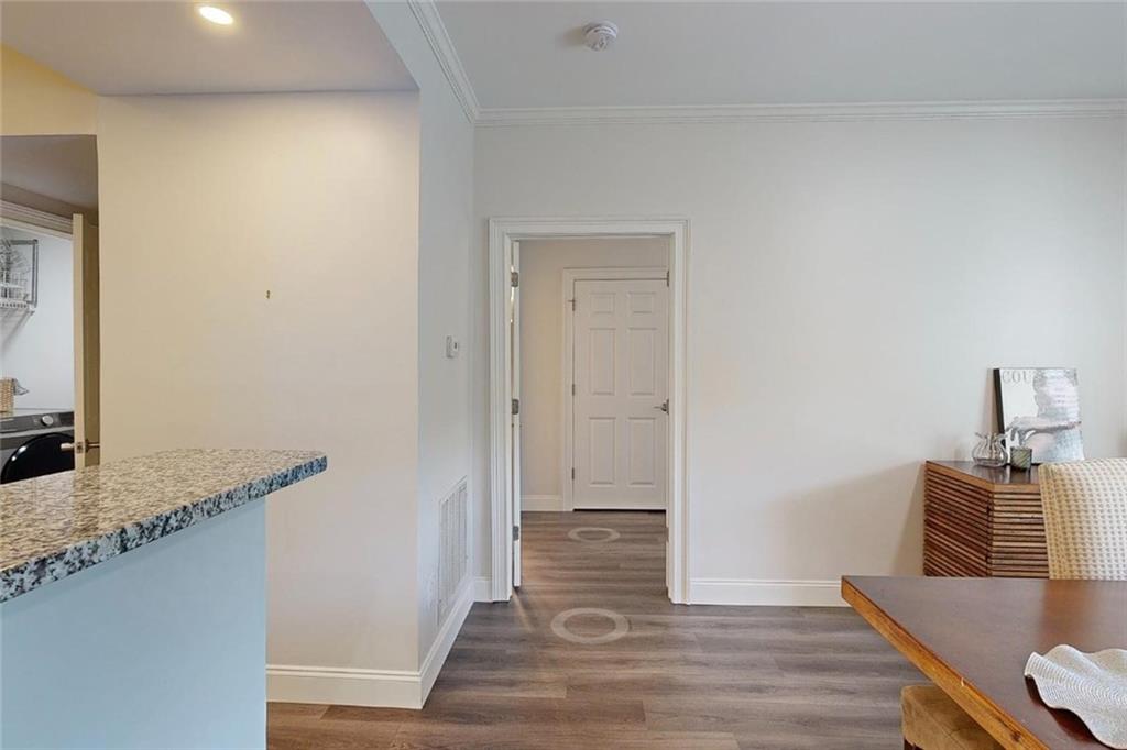3275 Lenox Road Northeast, Unit 413 Atlanta, GA 30324 - Photo 5 of 52 a view of a hallway with wooden floor and a cabinet