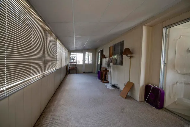 a view of an empty room and a window